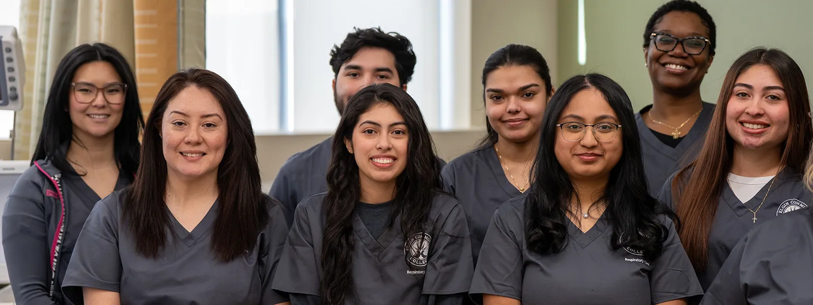 A group of respiratory care students smiling at the camera