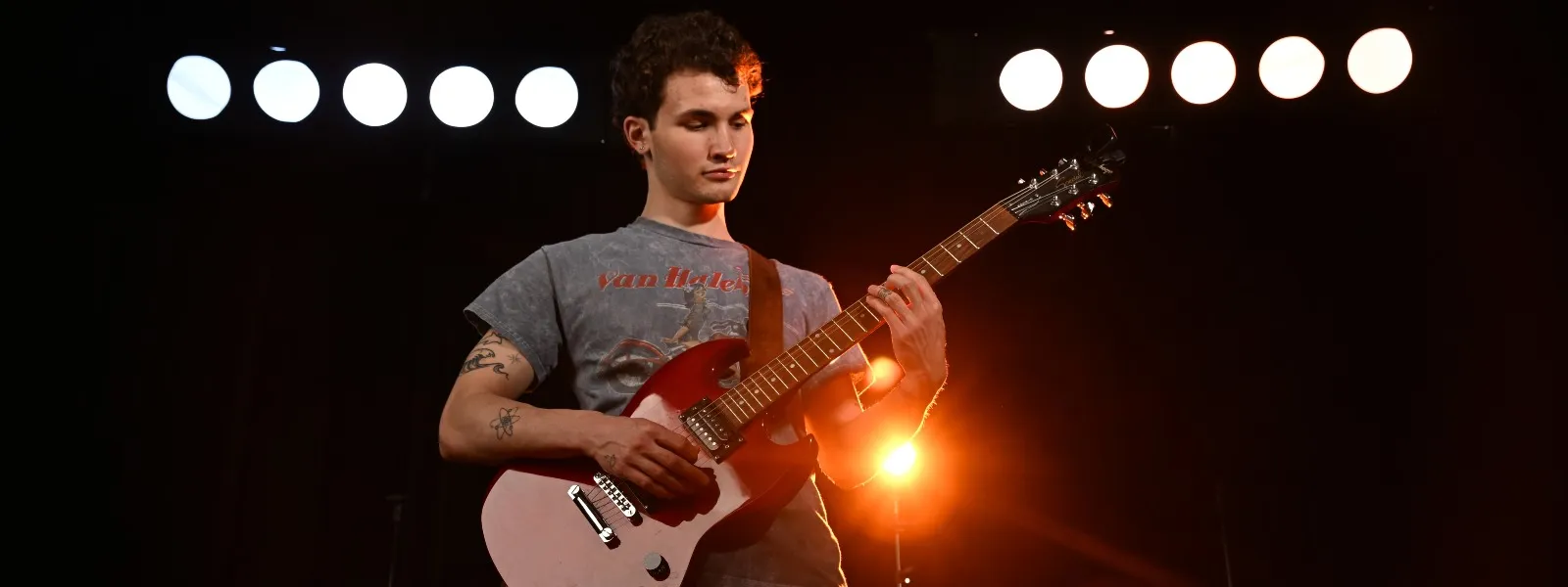 Student playing a guitar