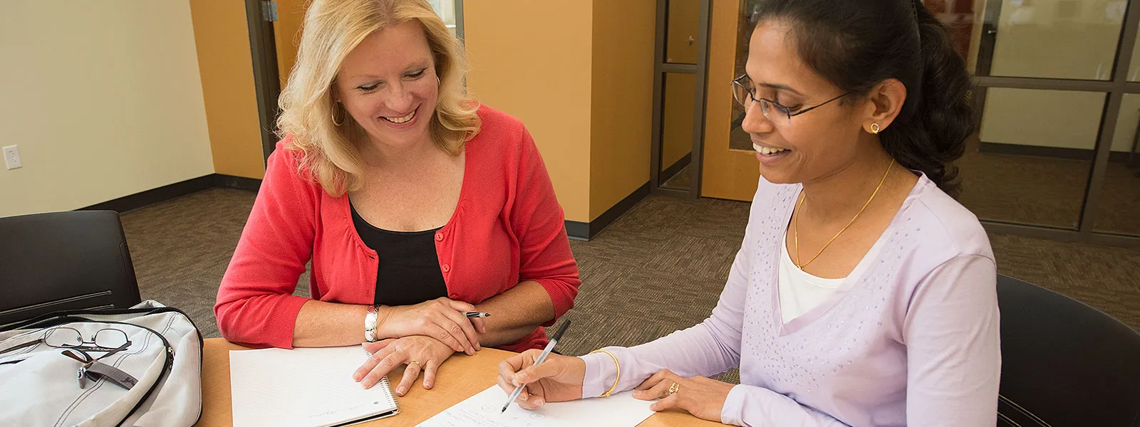 Image of instructor helping student.