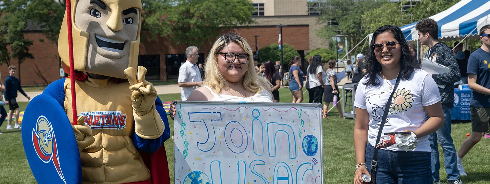 Students promote the club for students of all cultures at a campus event