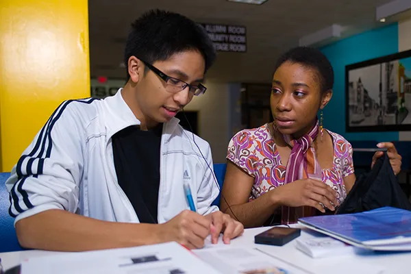 Two students of color studying together