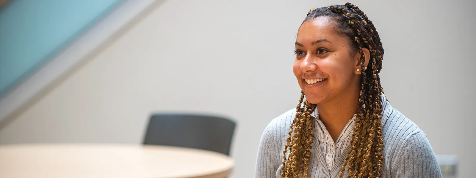 A student sitting at a table in designated space at the college.