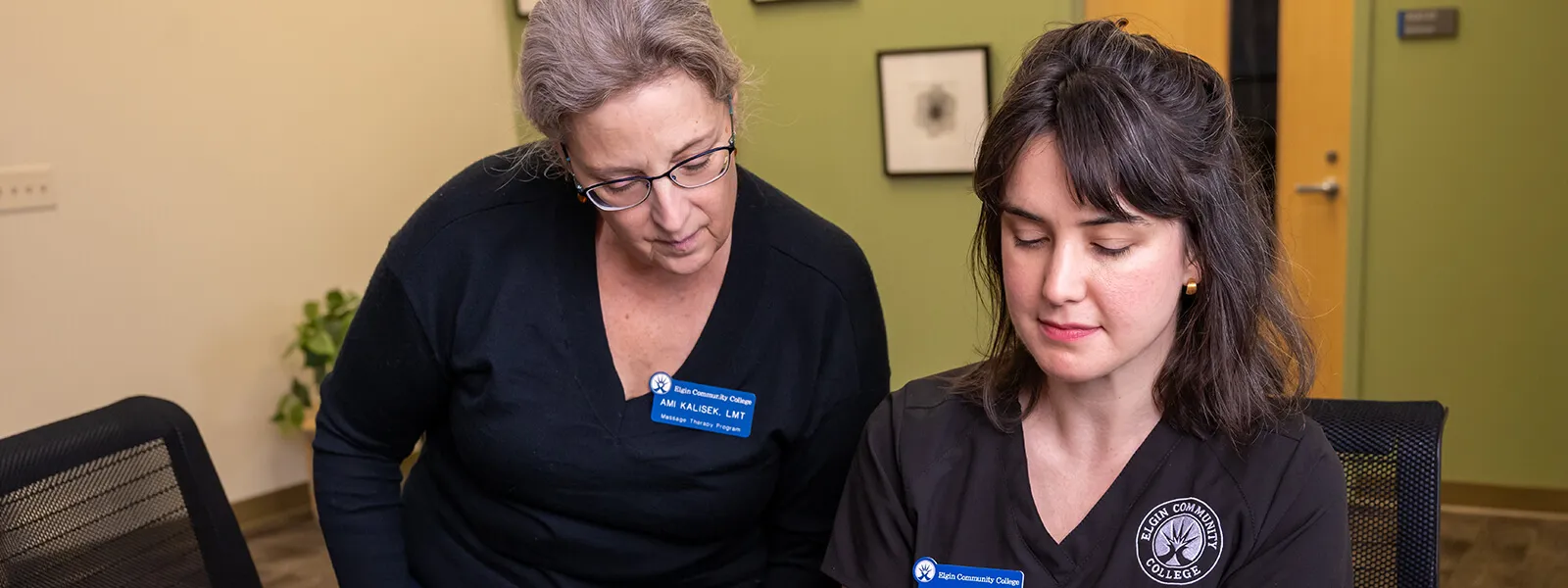 A student and teacher review information at a medical clinic