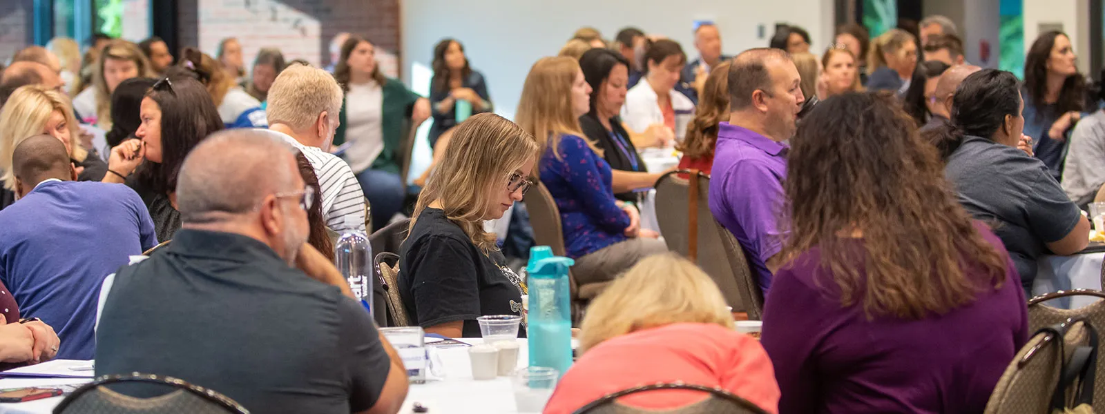 High School counselors gathered in Building E, Dining Room listening to the president's presentation.