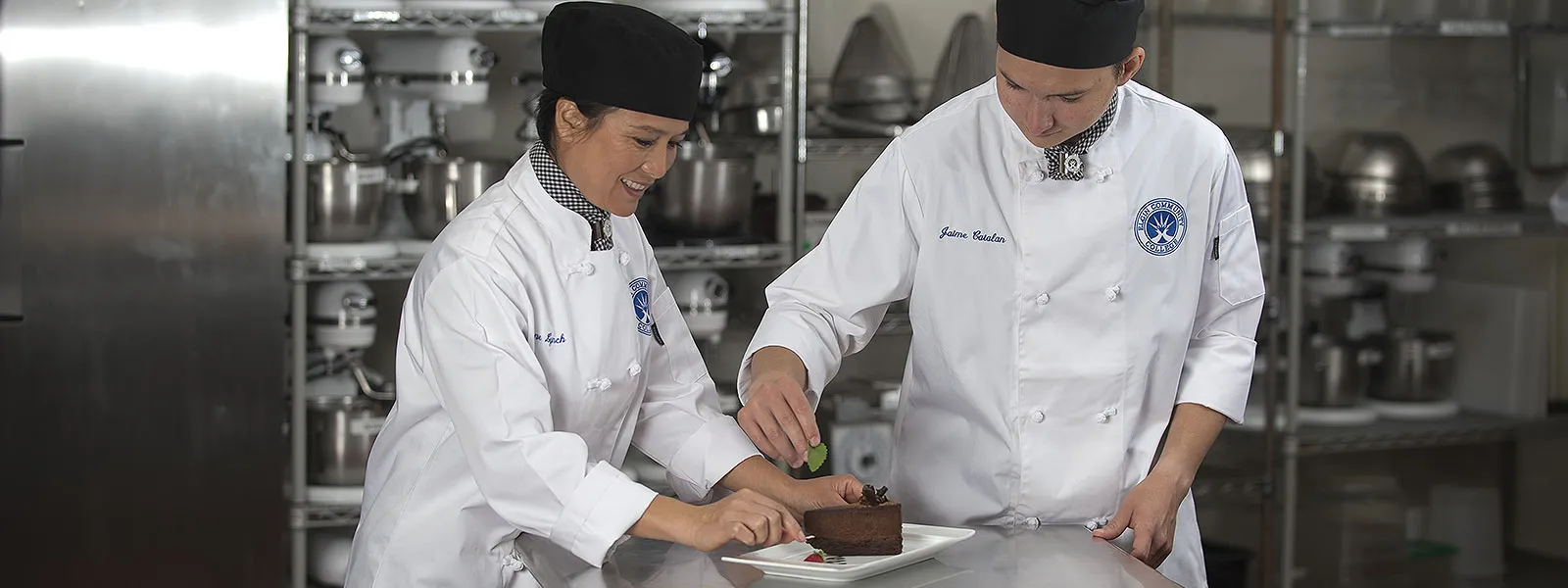 Close-up of pastry chefs preparing a dessert.