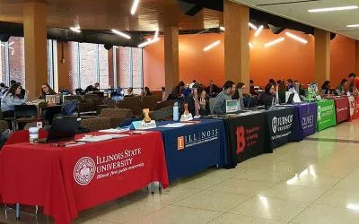 Colleges and universities set up tables during the transfer fair