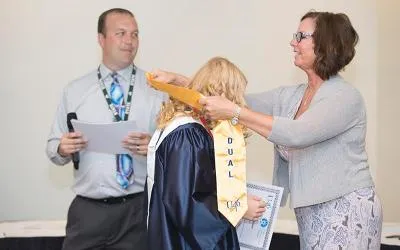 A student receives their Accelerate College diploma