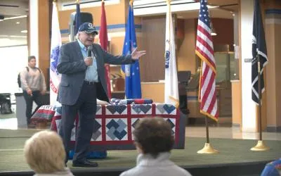 A student veteran addresses audience on Veterans' Day