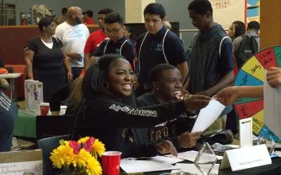Two students greet others during HBCU Fair