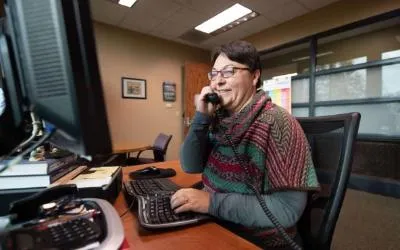 Jennifer McClure, managing director of enrollment services, making calls to near completers to help them return to ECC.