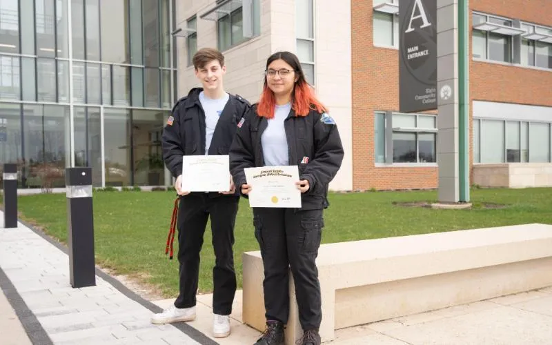 Local high school students Anthony Greco from South Elgin High School and Mariam Laila Ali from Streamwood High School outside of ECC with their EMT certificates