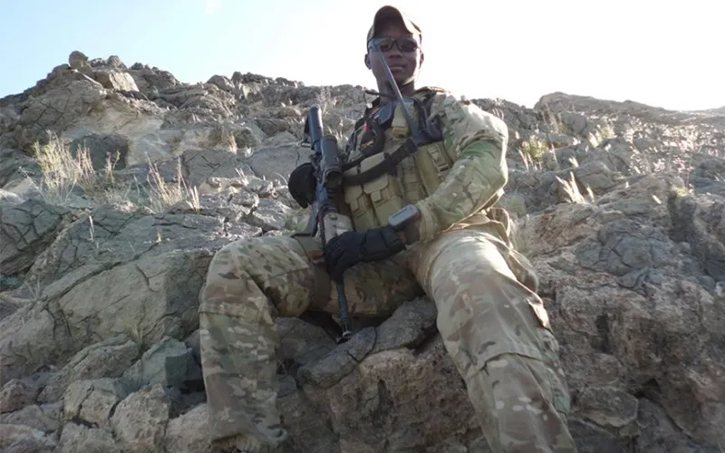 ECC Alum Zacharia Gai poses in his army uniform while on duty.