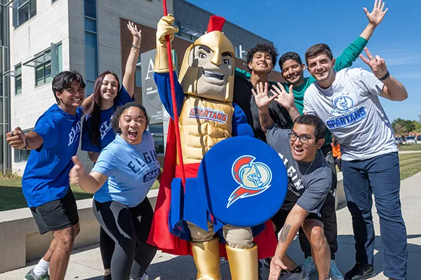 A group of students standing together with the Elgin Community College mascot, Spartacus