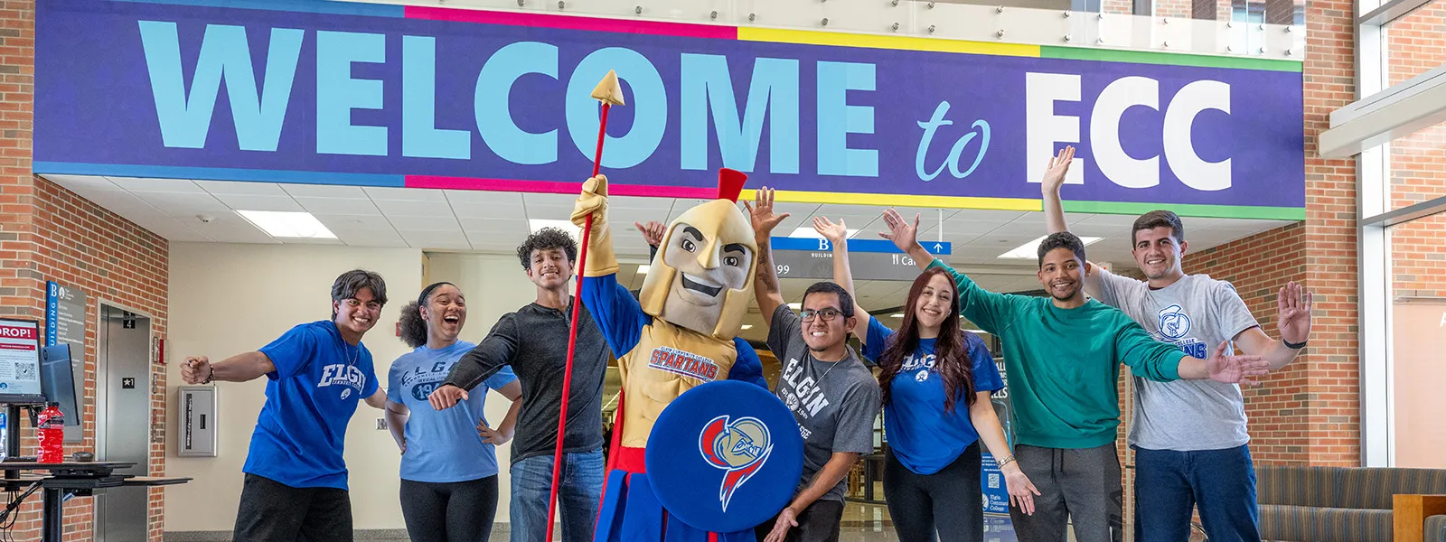 A group of students standing together with the Elgin Community College mascot, Spartacus