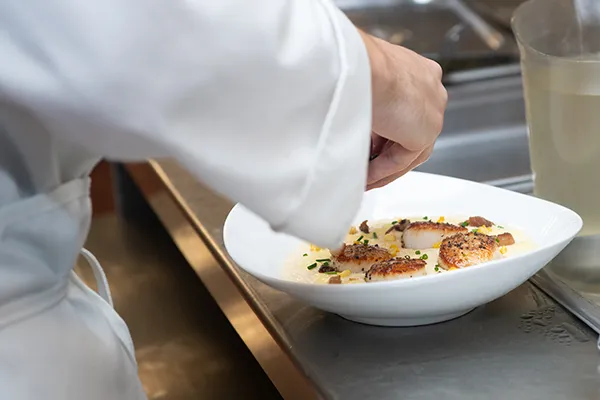 Chef adding finishing touches to a dish