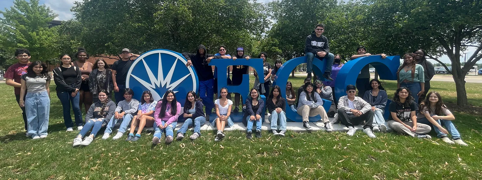 Students standing on ECC Letters