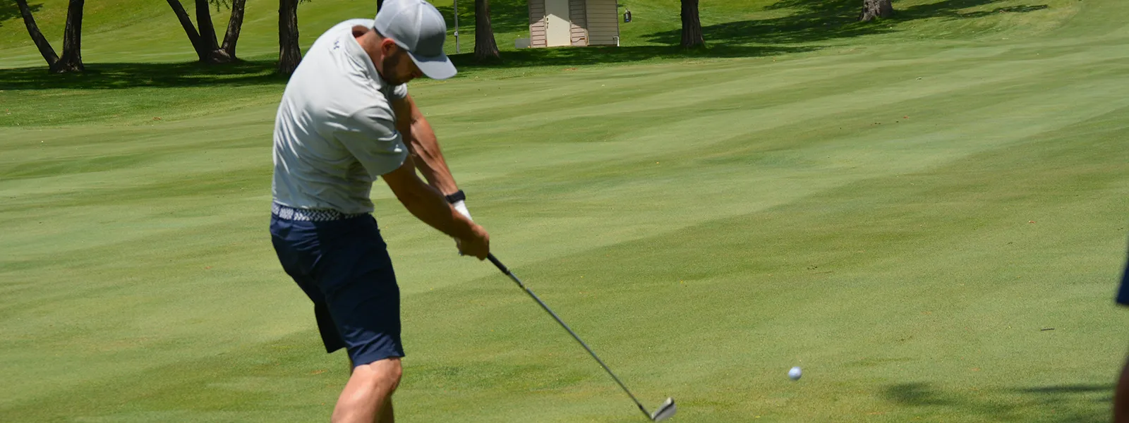 A golfer hitting the ball