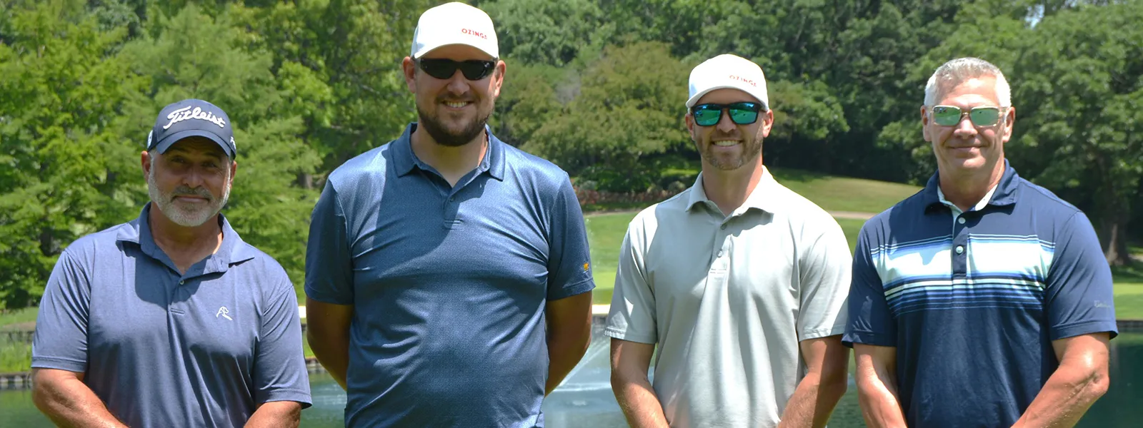 Golfers pose for a photo.