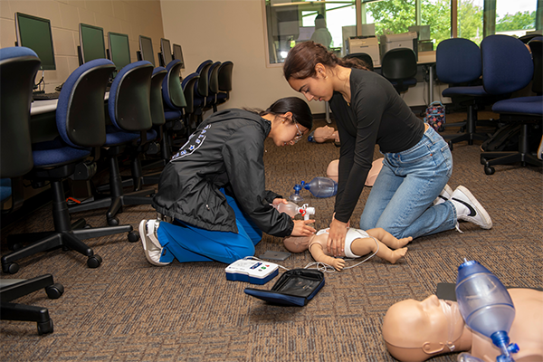 Students giving CPR