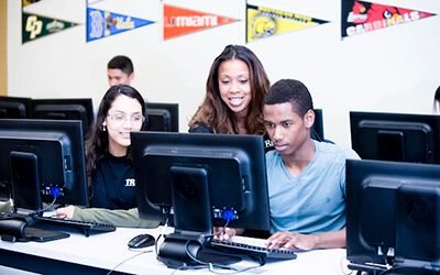 Students collaborating over a computer