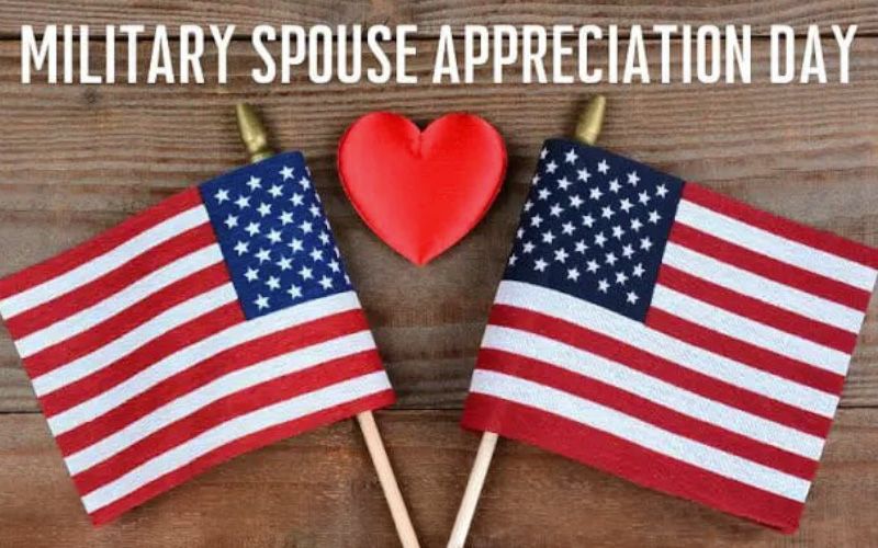 two american flags next to eachother with a heart in the middle in front of a wooden background